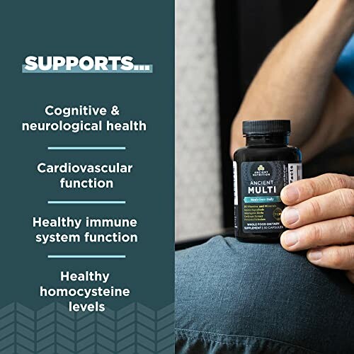 Hand holding a bottle of Ancient Multi supplement with health benefits listed.