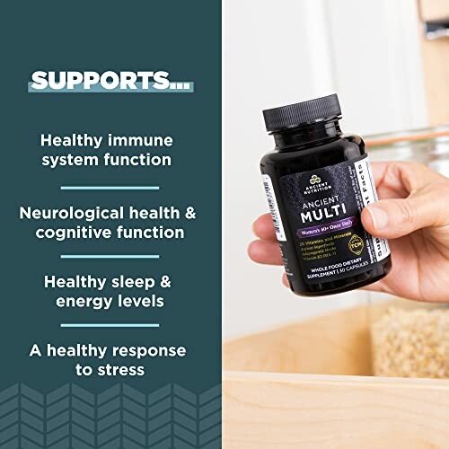 Hand holding a vitamin bottle with health benefits listed.