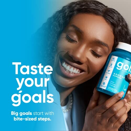 Smiling woman holding a bottle of gummy supplements.